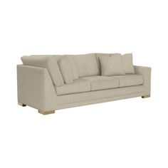 an image of a couch with pillows on the top and bottom half, in beige linen