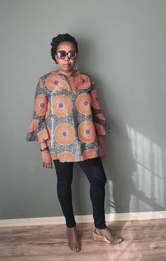 This beautiful African print tunic is made out of 100% wax cotton. It is an easy pull on top with no zippers or buttons. It can be worn for any occasion by styling it differently. Include your measurements in the order notes so we can make sure you are selecting the right fit. DETAILS & CARE - Full Length 30 inches - Sleeve length 24 inches - V-neck - Three-quarter sleeves - Pleat in the back - 100% wax cotton - Hand or machine wash cold recommended to preserve color brilliance Cotton Split Neck Blouse For Fall, Multicolor Long Sleeve Tunic With Block Print, Multicolor Smock Blouse With Long Sleeves, Multicolor Long Sleeve Smocked Blouse, Multicolor Long Sleeve Smock Blouse, Fall Cotton Blouse With Split Neck, African Tops For Women, Ladies Long Top, African Print Tops