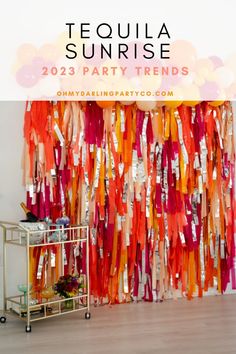 an orange and pink party backdrop with the words tequila sunrise in front of it