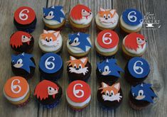 cupcakes with frosting are arranged in the shape of foxes and numbers on them