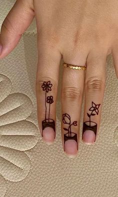 a woman's hand with tattoos on it