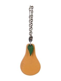 a pear shaped keychain hanging from a chain