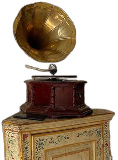 an antique record player with a brass horn on top