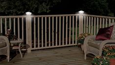 two wicker chairs sitting on top of a wooden deck