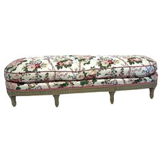 an upholstered bench with flowers on it