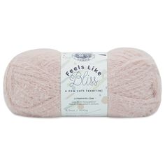 wool yarn ball in light pink with white lettering on the front and bottom, it has a