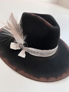 "100% Wool : Handmade Hat : Each hat is hand-designed by me. These are made per order. 5-7 Business Day Processing time. Each hat may have slight differences. One Size fits all adjust hat. Without adjustments, hat measures at 7 1/4. Brim 4.75\" Crown height 4.75\" Sweat band can be adjusted to fit smaller size. For any questions, please reach out :) RETURN POLICY: Hats that are customized will NOT be eligible for returns as these hats are made specifically to your liking. For hats that don't have any extra customizations added; hats with a design that I already sell, and nothing added and or changed to them: I offer returns for 50% refund as these hats are made per order. IF hat shows any signs of wear, hat will NOT be eligible for a refund. However, If you do have any problems with your o Distressed Bohemian Hat For Festivals, Rustic Distressed Hat For Festival, Bohemian Fedora Hat Band With Feather Trim, Bohemian Festival Hat Bands With Feather Trim, Bohemian Hat Band With Feather Trim, Bohemian Distressed Adjustable Hat Bands, Bohemian Distressed Fedora Hat, Bohemian Hats With Feather Trim For Rodeo, Bohemian Feathered Hat Bands For Country Events