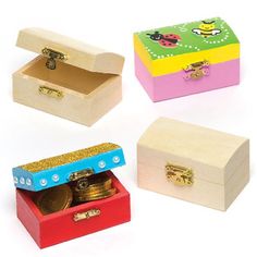 four small wooden boxes with different designs and colors, each containing a coin in the bottom