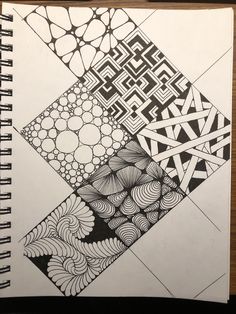 a notebook with black and white designs on it