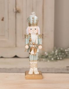 a nutcracker figurine on a table in front of a door