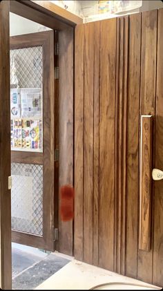 an open wooden door with newspaper on the front and side panels in between it's glass doors