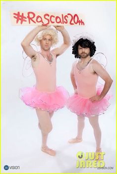 two people in pink tutus holding up a sign that says rascals 20