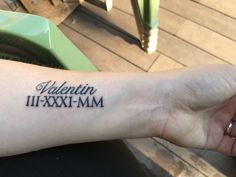 a person's arm with a tattoo that reads valentine in roman numerals