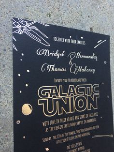 a black and gold wedding card with the words galactic union written on it's front