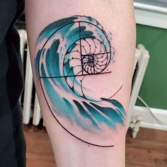 a person with a tattoo on their arm that has a wave in the center and a square at the bottom