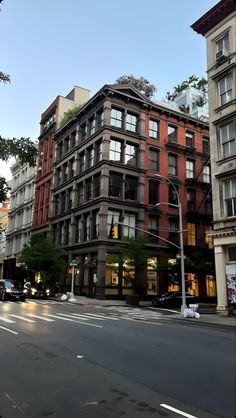 an empty city street with tall buildings on both sides