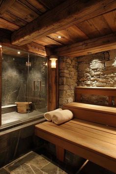 a wooden bench sitting in front of a stone wall next to a walk in shower