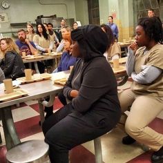 a group of people sitting at tables in a room