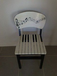 a wooden chair with musical notes painted on it