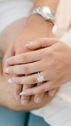 a close up of two people holding each other's hands