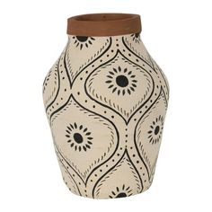 a white vase with black and brown designs on the front, sitting against a white background