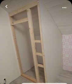 an empty room with a ladder in the corner