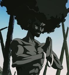 a man with an afro standing in front of some trees and holding his hands together