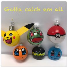 pokemon christmas ornaments are lined up against a white wall with the words, gotta catch em all