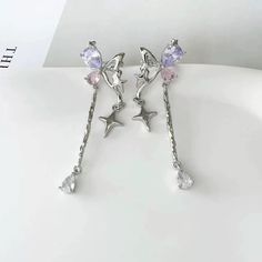 'SOLD AS A PAIR' ❤🦋Discover a touch of whimsy with our stunning **Silver Ear Cuff: Silver Butterfly uniquely adorned with sparkling pink and purple gemstones. Handcrafted with care, each piece reflects a beautiful blend of boho charm and Kawaii aesthetics, perfect for the modern woman who loves to express her individuality. These dainty dangling earrings are designed to catch the light beautifully, making them an ideal accessory for any occasion, from casual outings to special events. Crafted from high-quality, durable silver-plated material, this ear cuff is both lightweight and comfortable to wear. The elegant butterfly design symbolizes transformation and beauty, while the vibrant gemstones add a playful pop of color. Measuring approximately 2 inches in length, these earrings drape del Ear Cuffs Aesthetic, Virtual Angel, Purple Gemstones, Ear Cuff Silver, Earrings Kawaii, Korean Earrings, Earrings Aesthetic, Silver Ear Cuff, Earrings Cute