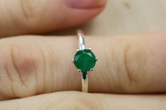 This is a beautiful Brazilian Emerald set in Sterling Silver. This amazing stone has the perfect deep green color that many look for in Emeralds accented beautifully by a 6 prong setting! This stone has visible inclusions and opaque clarity which is very common with Emeralds but also has a nice luster, you will not be disappointed!  Emeralds are the birthstone for May!  This perfect sized 6mm round cut Emerald weighs 0.740 and will go great with most styles or occasions. The size of these perfec Classic Green Heart Cut Rings, Green Heart Cut Emerald Ring For Formal Occasions, Heart Cut Green Emerald Ring For Formal Occasions, Formal Green Heart Cut Emerald Ring, Elegant Heart Cut Green Emerald Ring, Elegant Green Emerald Heart Cut Ring, Elegant Green Heart Cut Emerald Ring, Emerald Gemstones With Center Stone In Round Cut, Round Cut Emerald Gemstone With Center Stone