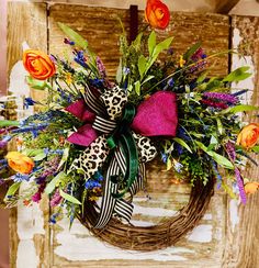 a leopard print bow on a wreath with flowers