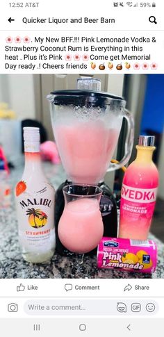 a blender filled with pink liquid next to other items on top of a counter