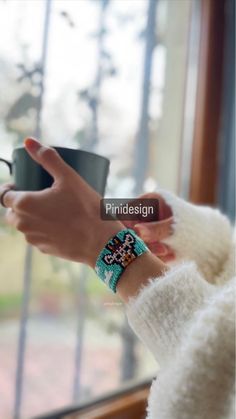 a woman is holding a coffee cup in her hand with the words pride design on it