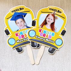 two school bus shaped magnets with the words kinder grad on them