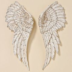 two white angel wings on top of each other in front of an instagram page