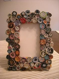 a photo frame made out of rolled up paper with the letter d in it's center