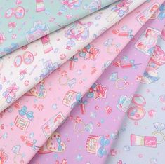 many different colored fabrics are shown together in this close up photo, including pink and blue