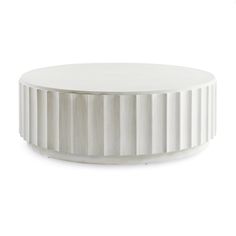 a round white table sitting on top of a white floor