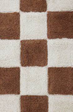 a brown and white checkered rug on the floor