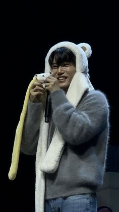 a man in a bear costume holding a cell phone