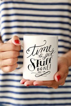 a woman holding a coffee mug with the words time to get stuff done