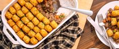 a casserole dish with tater tots and ground beef on the side