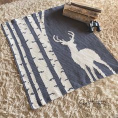 a rug that has a deer on it and some books sitting on top of it