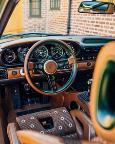 the interior of an old car with wood trim and gauges on it's dashboard