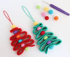 two crocheted christmas ornaments next to a pair of knitting needles and yarn balls