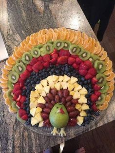 a platter filled with fruits and vegetables on top of a table