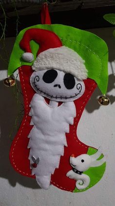 a christmas stocking hanging on the wall with a skeleton in it's santa hat