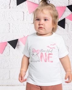 This adorable baby t-shirt makes the perfect outfit for your little ones Halloween 1st birthday party. If you are looking for a cute birthday theme this October, this cute pink ghost design is perfect for any Boo-tiful One's birthday bash. This t-shirt captures the October spirit and adds a touch of coquette spooky cuteness to the festivities. A must-have for parents planning a Halloween-themed birthday party for their little one. Product features - Fiber composition: 100% cotton for solid colors; varying percentages for Heather and Athletic Heather colors - Side seams provide structure and shape to the garment - Necktape for added comfort and to prevent stretching - Made of 100% airlume combed and ringspun cotton - Light fabric with a regular fit Care instructions - Machine wash: cold (ma Baby Birthday Shirts, Outfit Coquette, Thema Halloween, Coquette Halloween, Boo Tiful, 1st Birthday Outfit