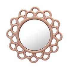 a round mirror with an intricate design on it