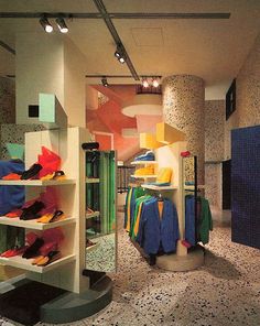 the inside of a clothing store with shoes on display